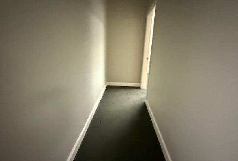 Corridor featuring baseboards