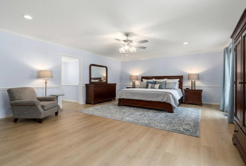 Bedroom featuring light wood-style floors, crown molding, recessed lighting, and a ceiling fan