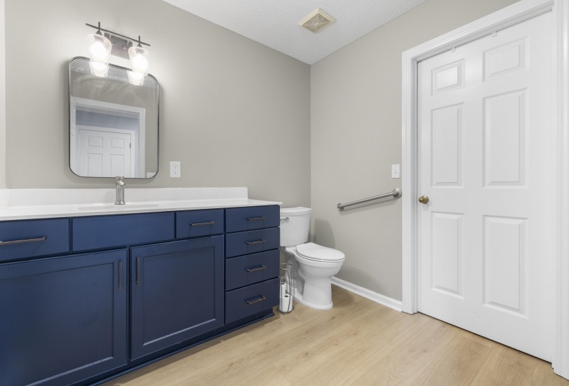 Bathroom with vanity and light wood finished floors
