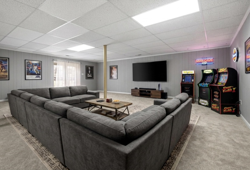 Play room with wood walls, carpet floors, and a paneled ceiling