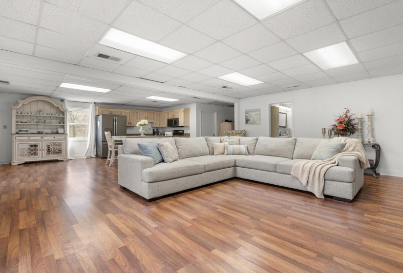 Living room featuring a paneled ceiling and light wood-style floors