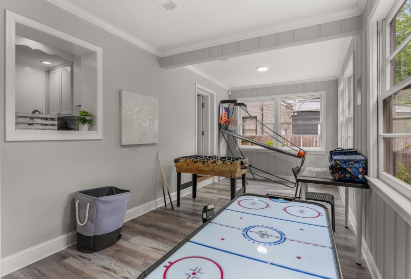 Playroom with light wood-style floors and ornamental molding