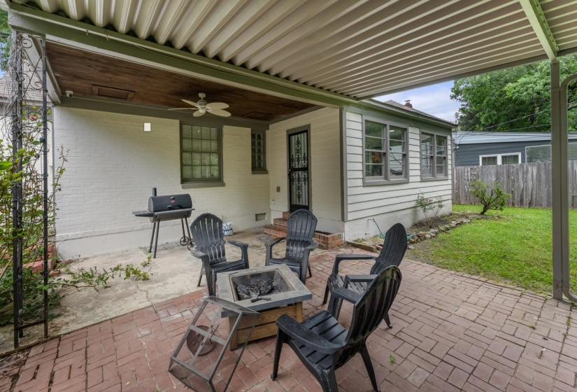 View of patio / terrace with grilling area, an outdoor fire pit, and a ceiling fan