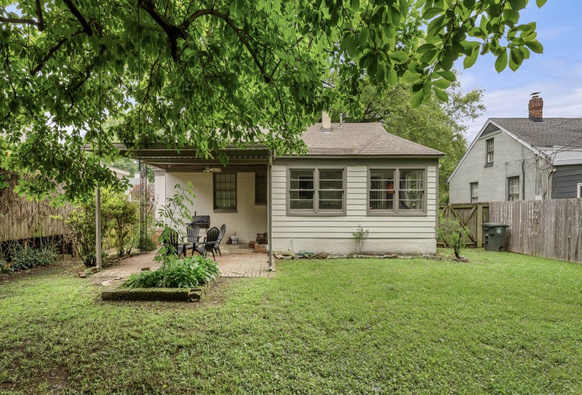 Rear view of house with a patio area, a fenced backyard, a gate, and a shingled roof