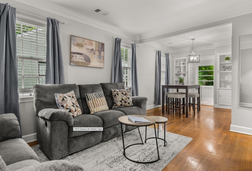 Living room featuring hardwood / wood-style floors and crown molding