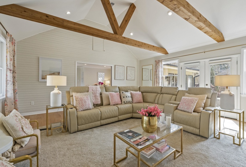 Living area with plenty of natural light, french doors, carpet flooring, and recessed lighting