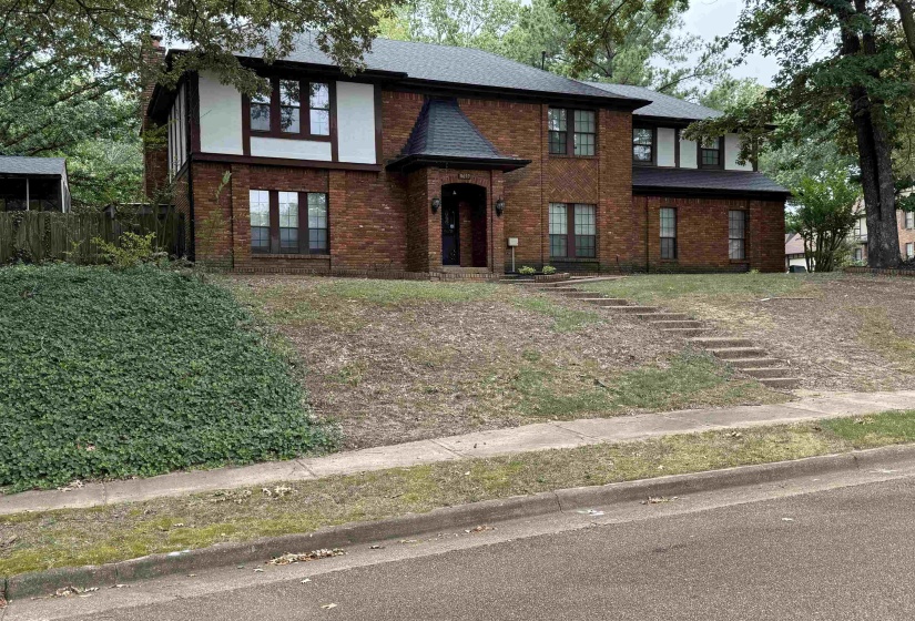 Tudor house featuring brick siding