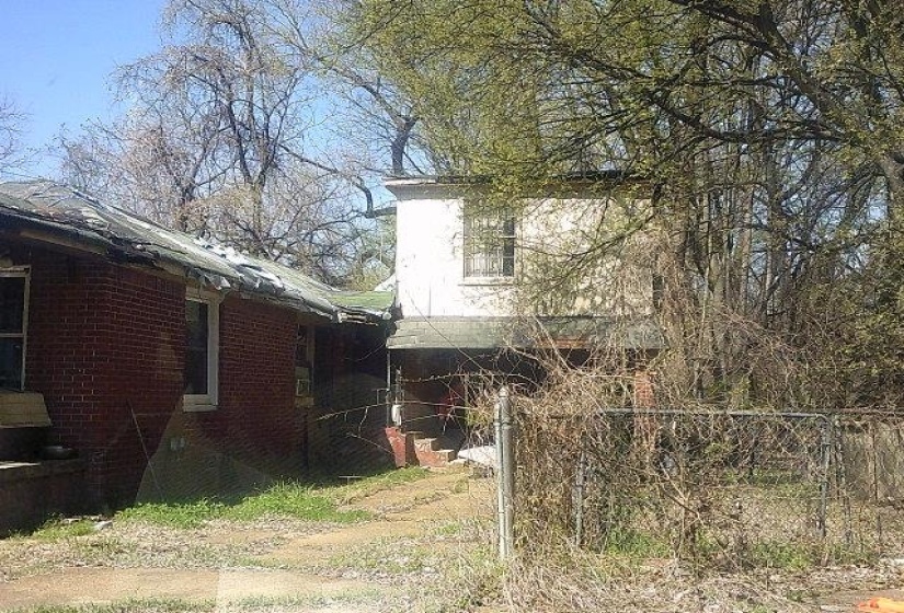 View of side of home with brick siding