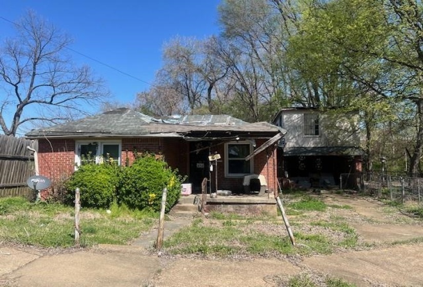 View of front of home featuring brick siding and covered porch
