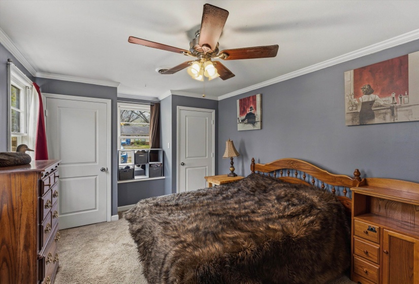 Bedroom with ornamental molding and ceiling fan