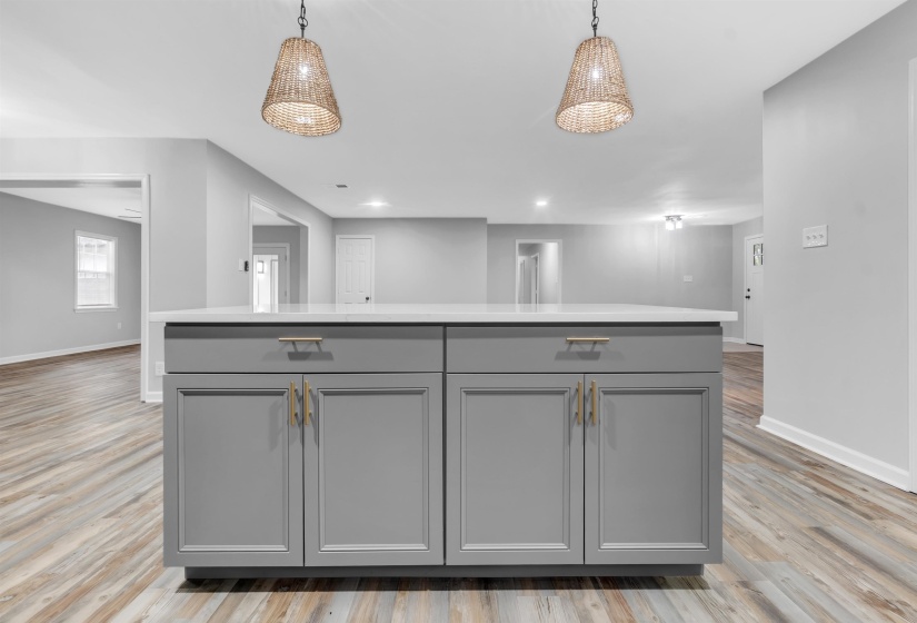 Kitchen with gray cabinetry, baseboards, light countertops, and recessed lighting