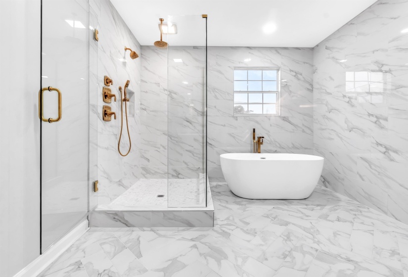 Full bathroom with a marble finish shower, marble finish flooring, and a freestanding tub