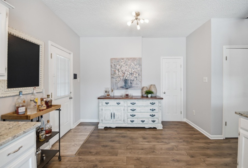 Dining room featuring dark wood-style floors and a textured ceiling