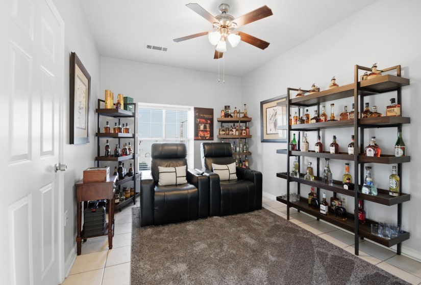 Sitting room featuring a ceiling fan and light tile patterned flooring