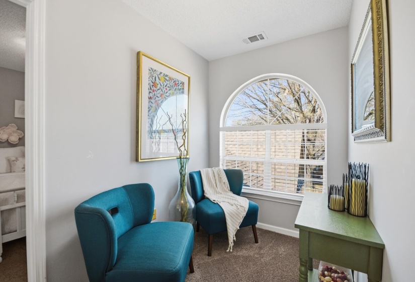 Sitting room featuring dark carpet and baseboards
