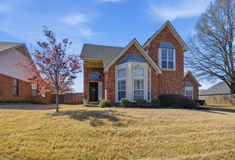 Traditional-style house featuring brick siding