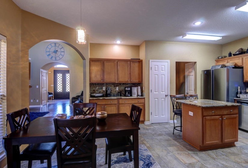 Dining space featuring arched walkways and recessed lighting
