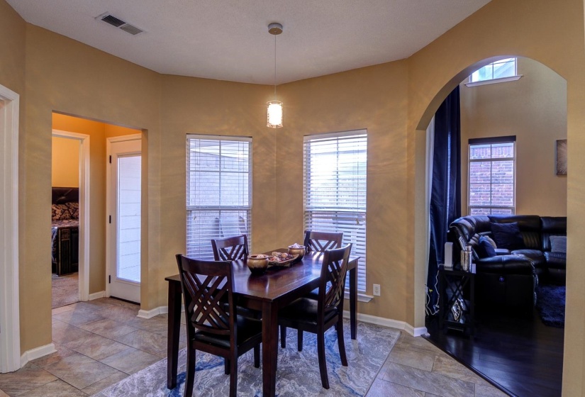 Dining space featuring arched walkways and baseboards