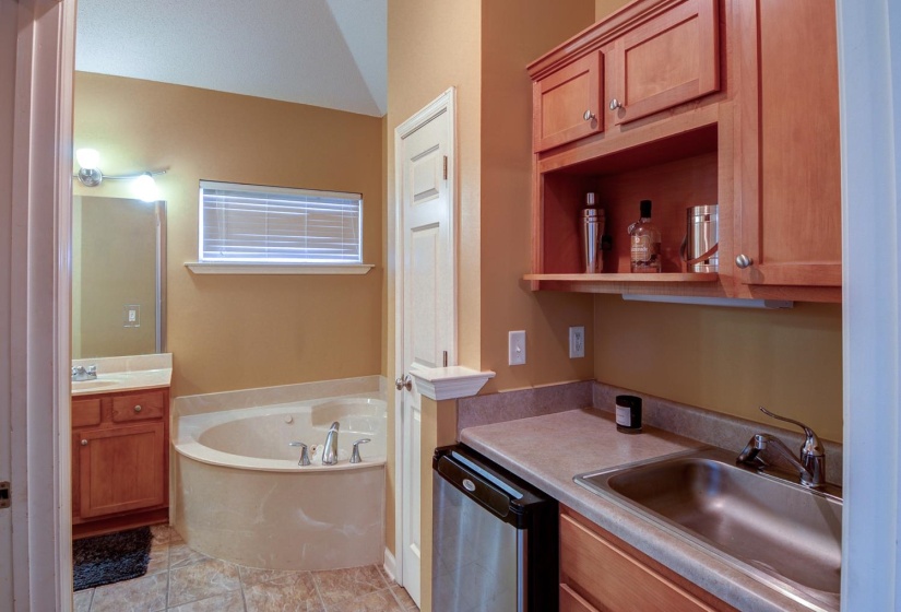 Bathroom with two vanities and a garden tub