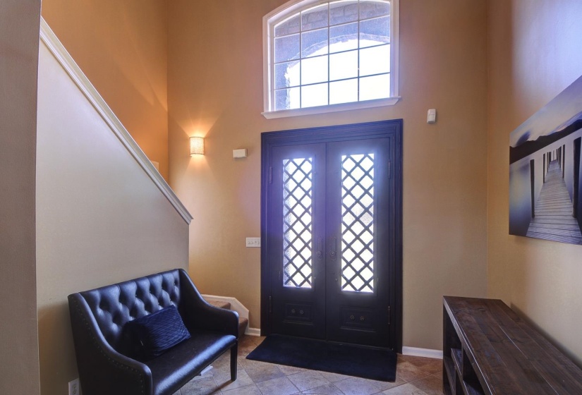 Foyer with a high ceiling and baseboards