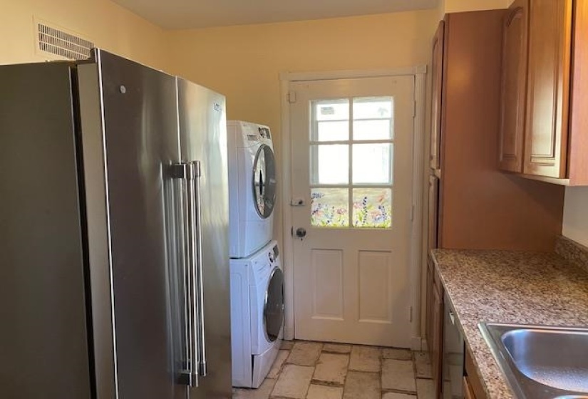 Laundry area featuring stacked washer and dryer