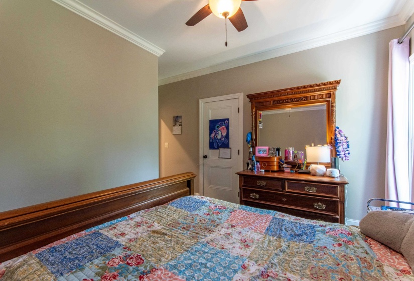 Bedroom featuring crown molding and ceiling fan