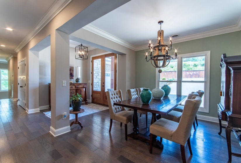 Dining area featuring a chandelier, dark hardwood / wood-style floors, and ornamental molding