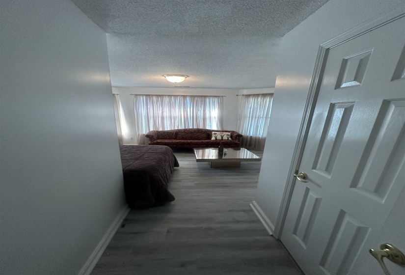 Bedroom featuring a textured ceiling and dark wood-style flooring