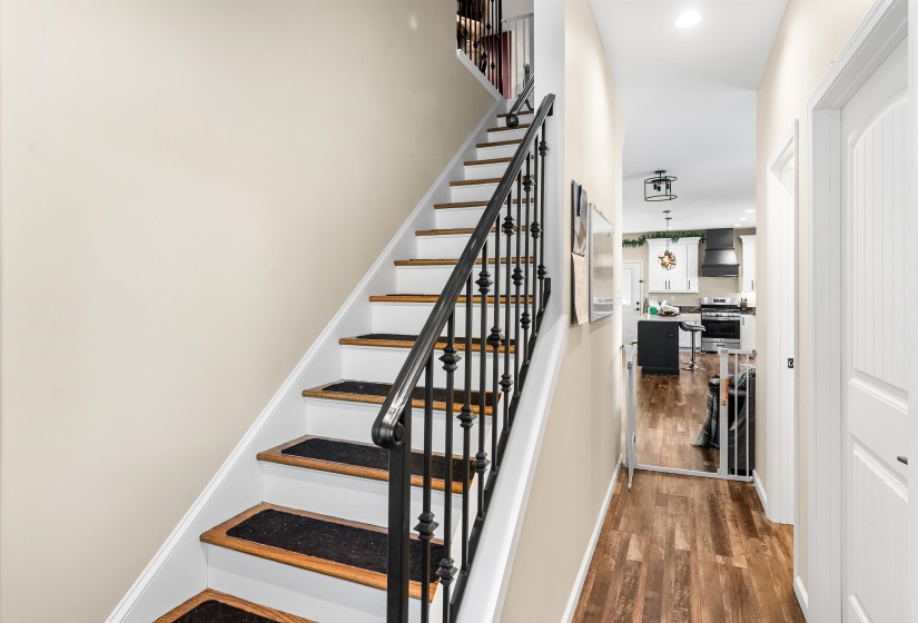 Stairs featuring wood finished floors and baseboards