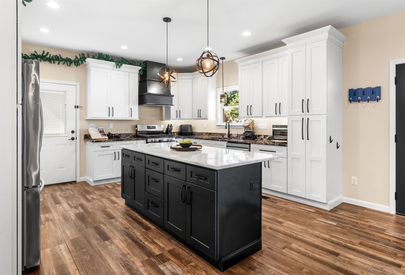 This gourmet kitchen offers gorgeous counter tops, gas cooking, an oversized island, & much more!