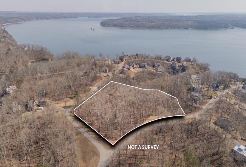 Aerial view of property's location with property boundaries highlighted and a nearby body of water