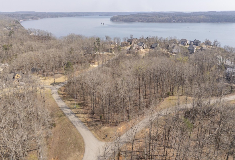 Drone / aerial view of a large body of water and a heavily wooded area