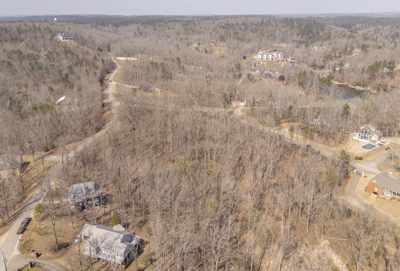 Aerial view of property and surrounding area with a forest