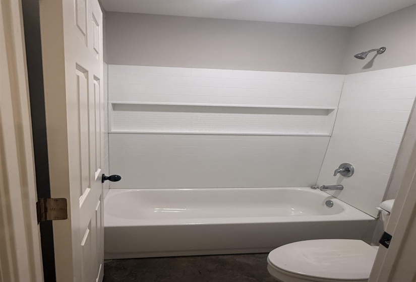 Full bath featuring bathing tub / shower combination and toilet