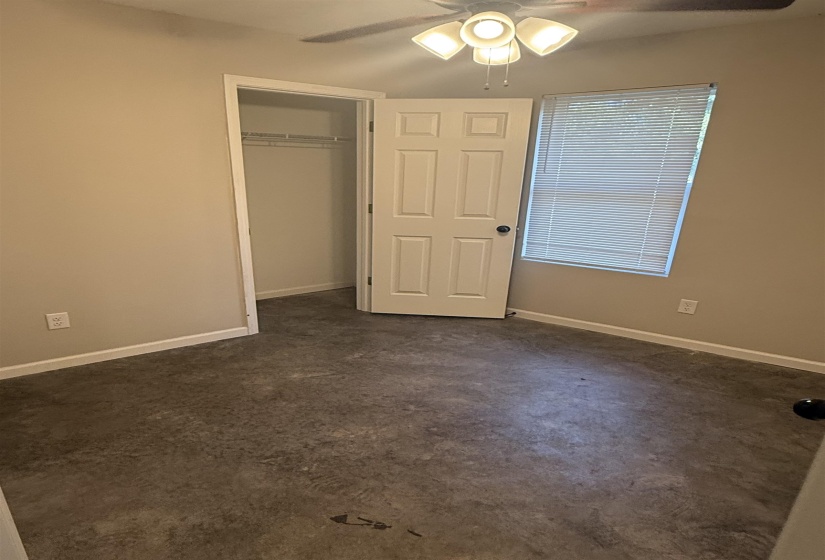 Unfurnished bedroom featuring ceiling fan and a closet