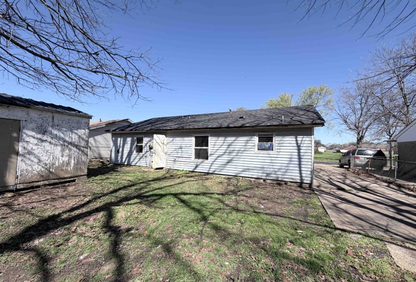 Back of house featuring a storage shed