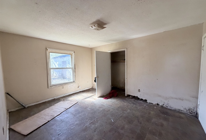 Unfurnished bedroom with a closet and a textured ceiling