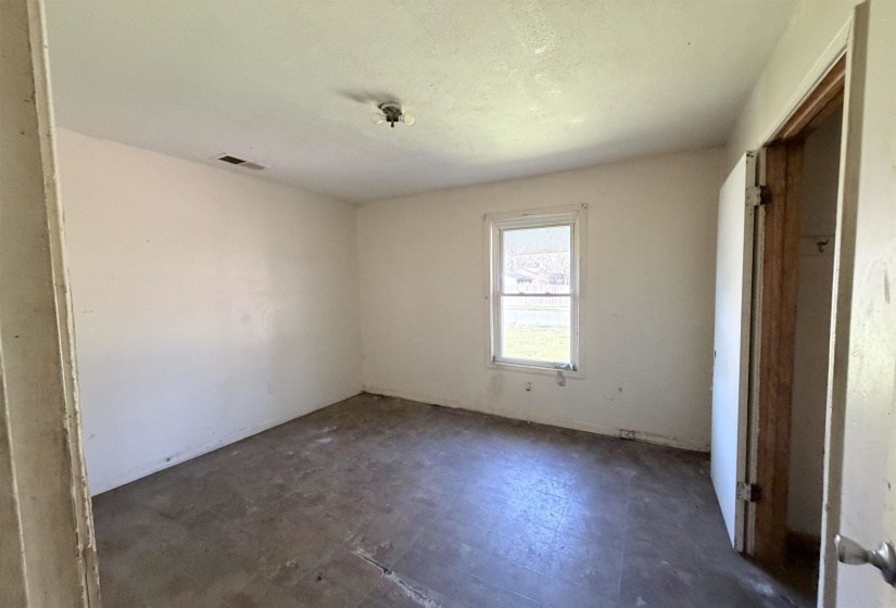 Unfurnished bedroom with dark floors