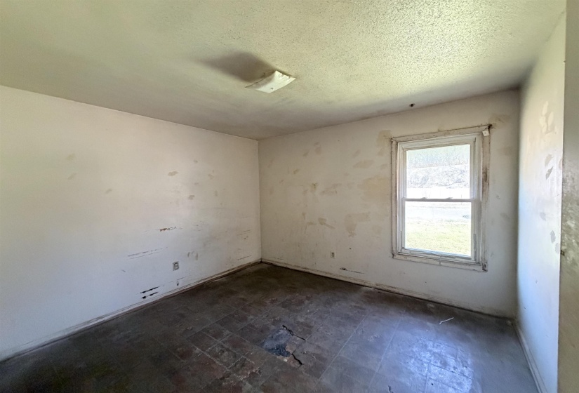 Empty room featuring a textured ceiling