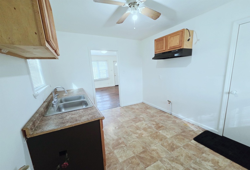 Kitchen with ceiling fan and light countertops