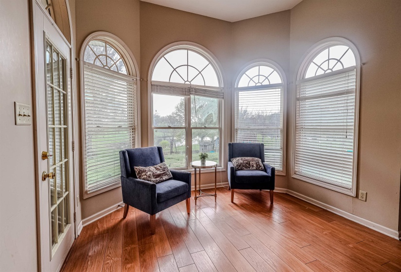Living area featuring plenty of natural light, baseboards, and wood finished floors