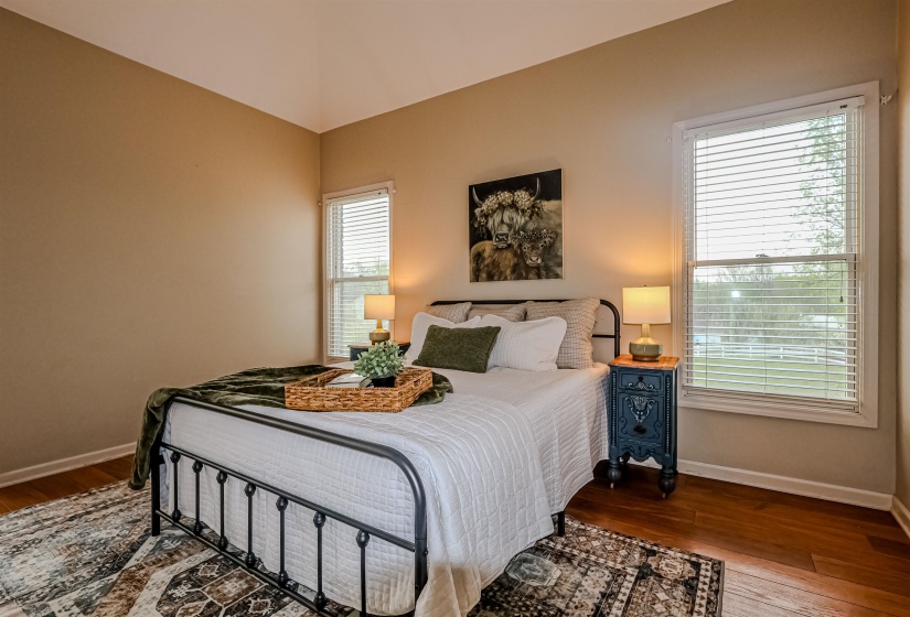 Bedroom with baseboards and wood finished floors