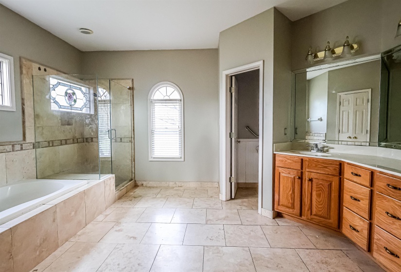 Bathroom with tile patterned floors, vanity, a shower stall, and a bath