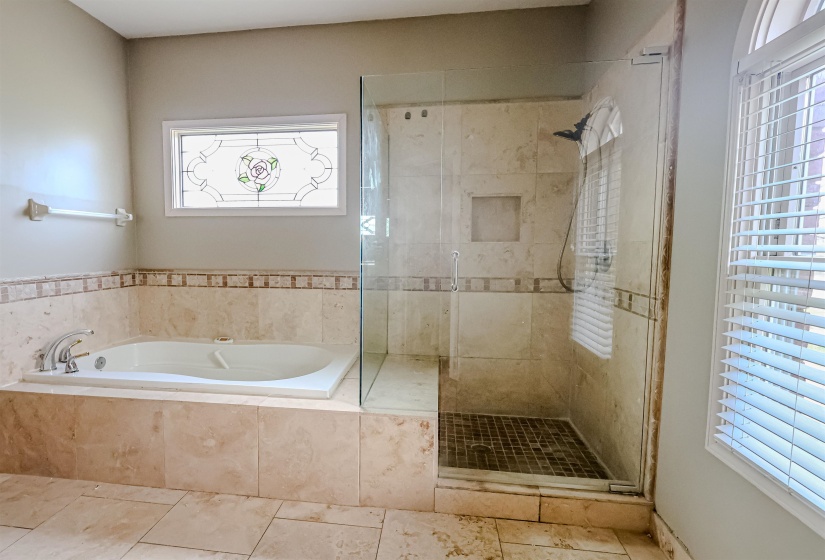 Bathroom featuring a bath and a shower stall