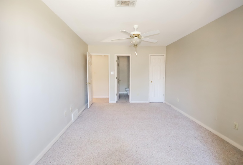 Unfurnished bedroom featuring light colored carpet and ceiling fan