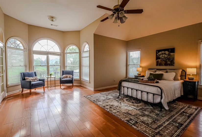 Bedroom featuring baseboards, lofted ceiling, ceiling fan, and wood finished floors