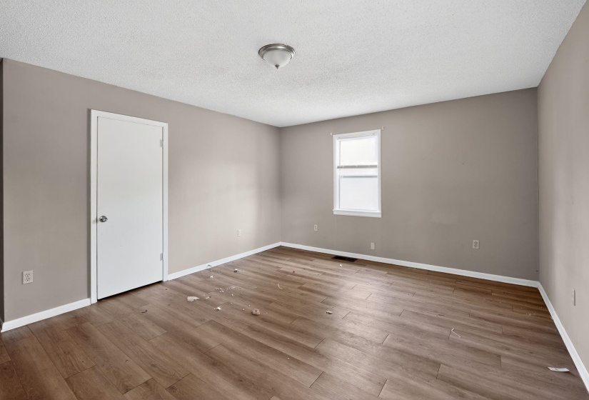 Spare room featuring a textured ceiling and light wood-style flooring