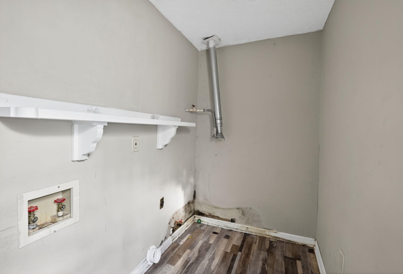 Laundry room featuring washer hookup, wood finished floors, and hookup for a gas dryer