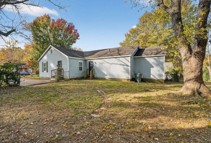 View of side of property with a lawn