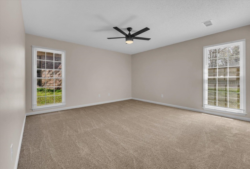 Unfurnished room with light carpet and ceiling fan
